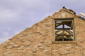 Detail of brick house ruined by a tornado that stripped away the roof.jpeg