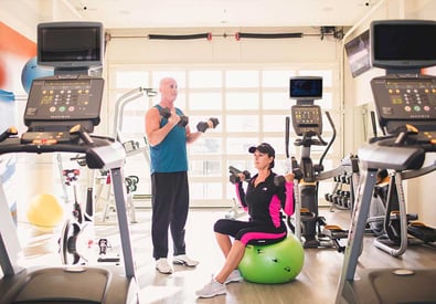 couple working out in fitness center