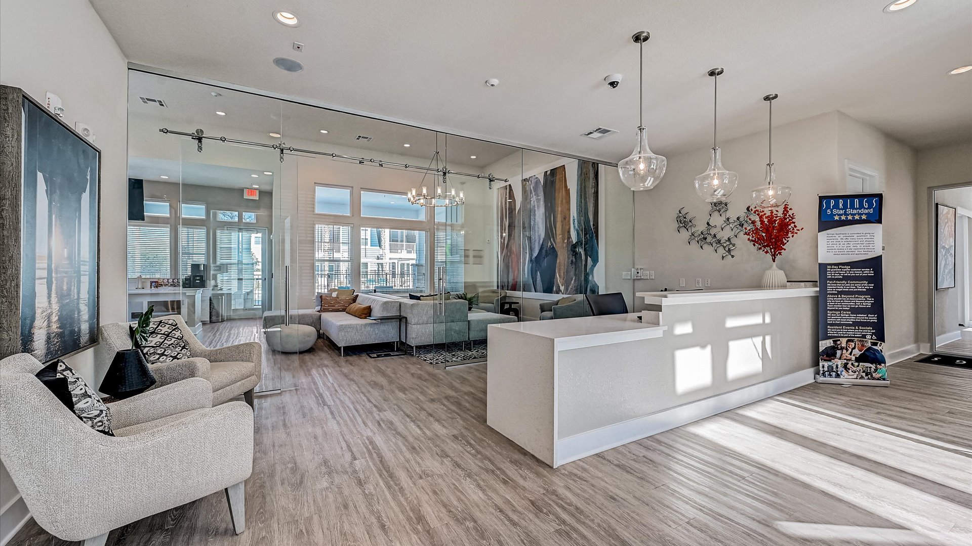 Modern Clubhouse Entrance with Glass wall and Leasing Desk at Springs at Flagler Center Apartments in Jacksonville, FL