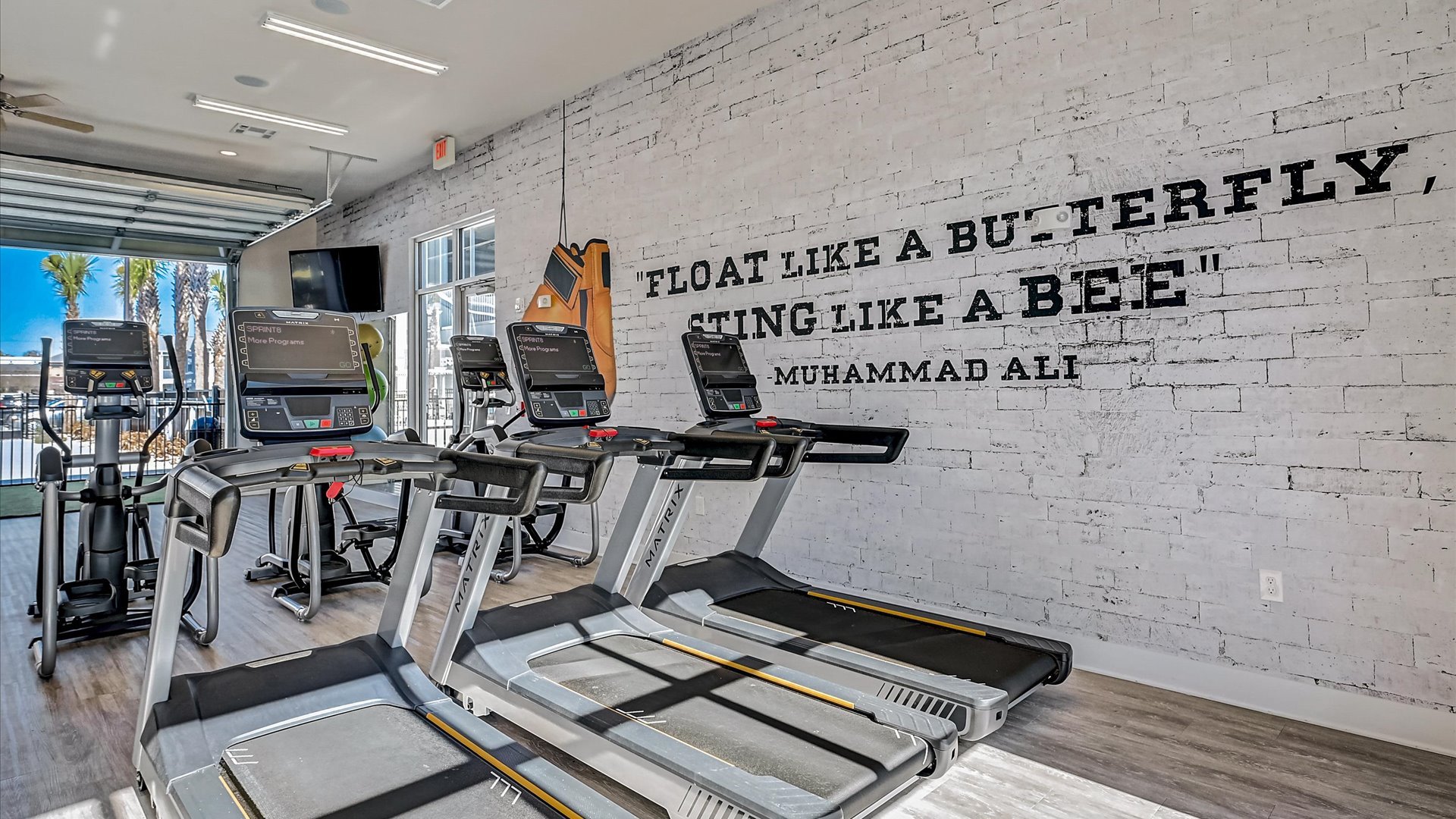 Gym with Treadmills and Bike Machines open to the Pool Amenity