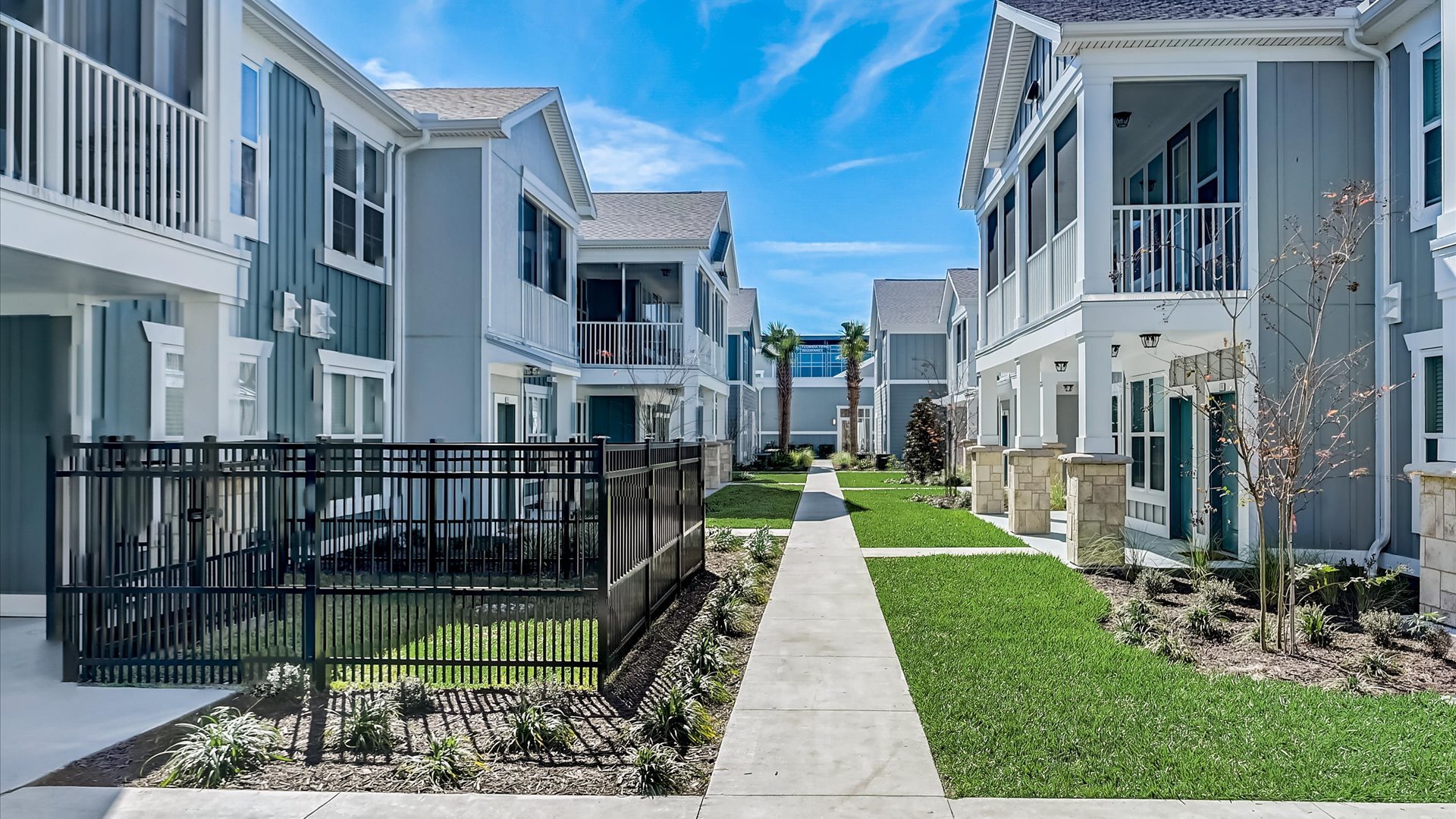 Gated Yard and Sidewalk through Community at Springs at Flagler Center Apartments in Jacksonville, FL
