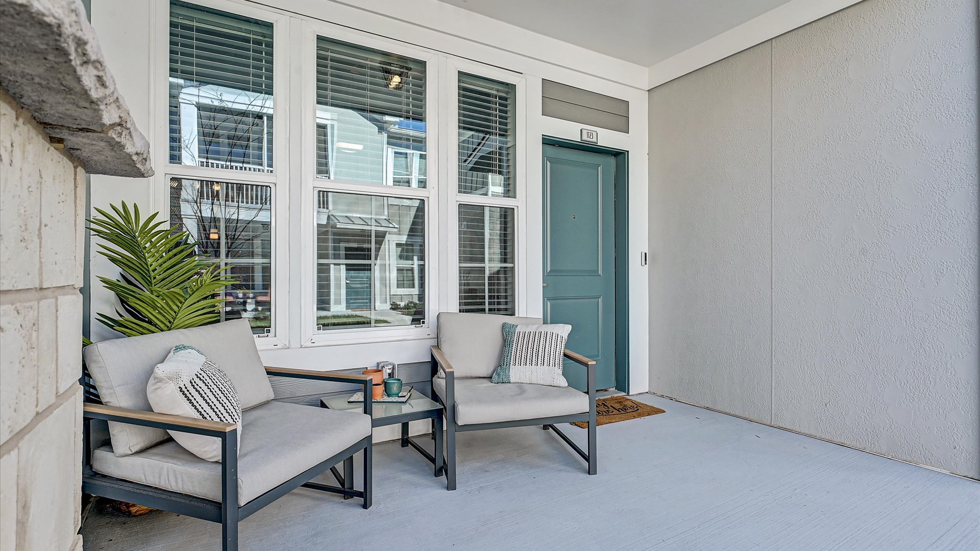Porch with Chairs and Blue Door Springs at Flagler Center Apartments in Jacksonville, FL