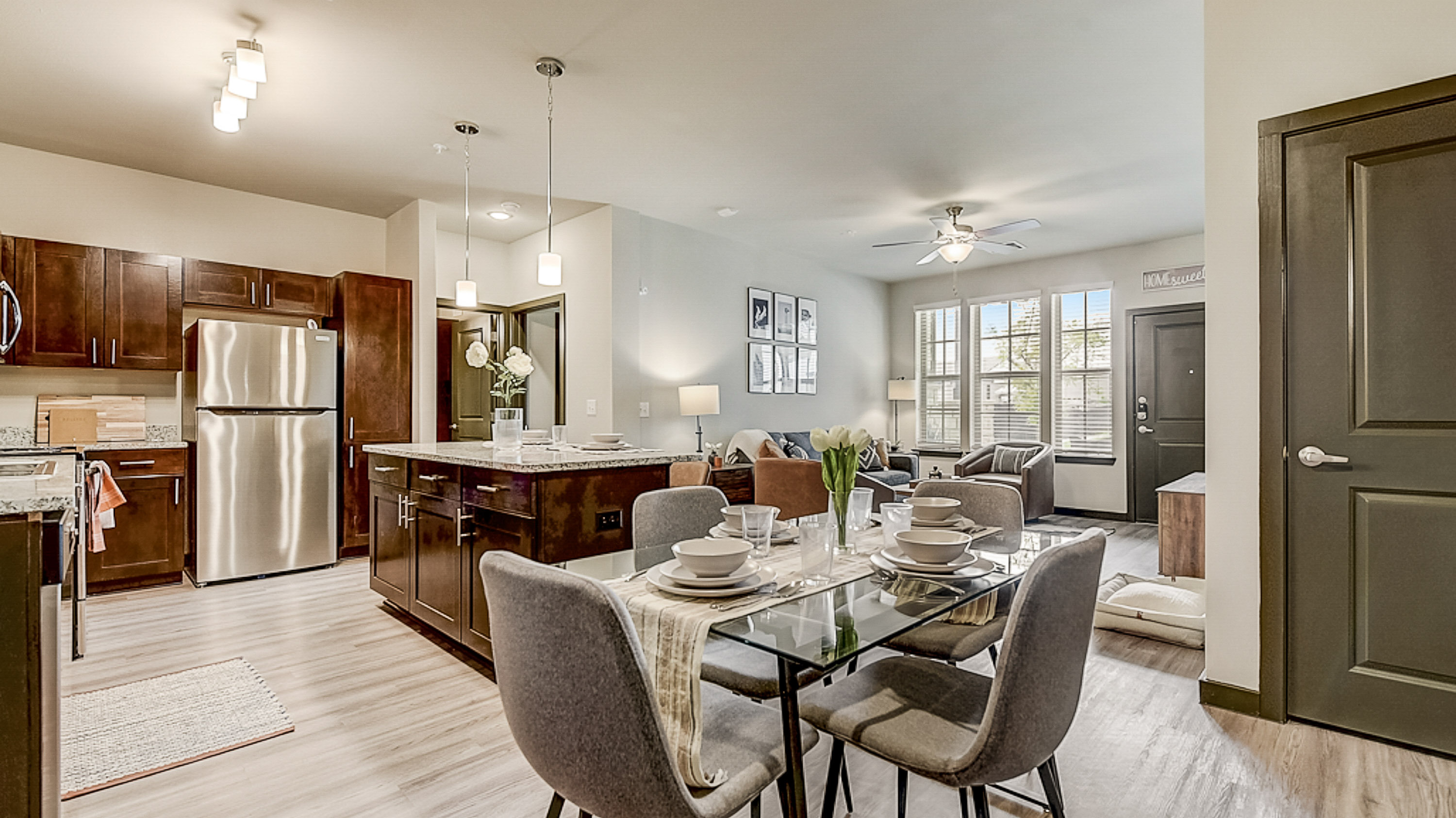 Dining area and huge island looking into the stylish living room at Springs at Grand Prairie apartments.