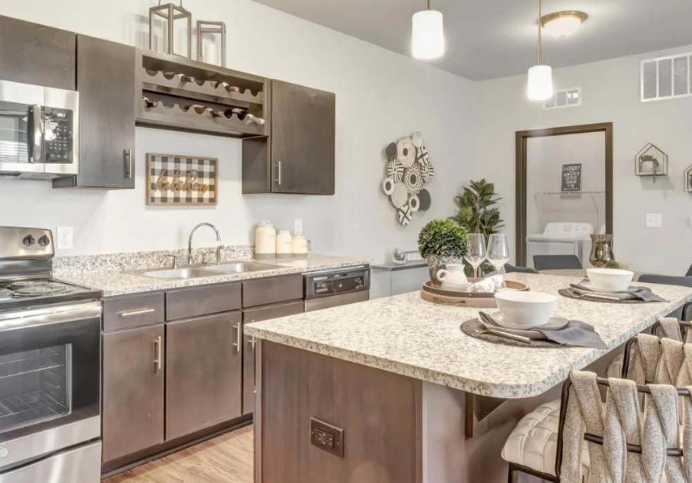 Luxury apartment kitchen with granite countertops and stainless steel appliances at Springs at La Grange.