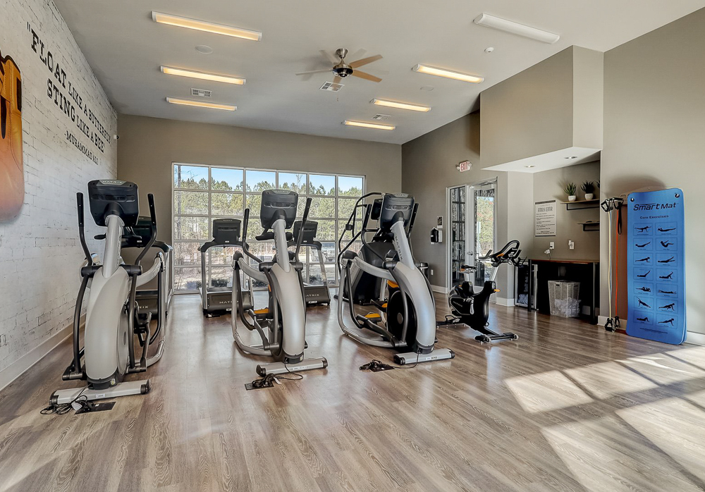 Gym with yoga mat, excersize bikes, and protein barat Springs at Newnan Apartments in Georgia-38