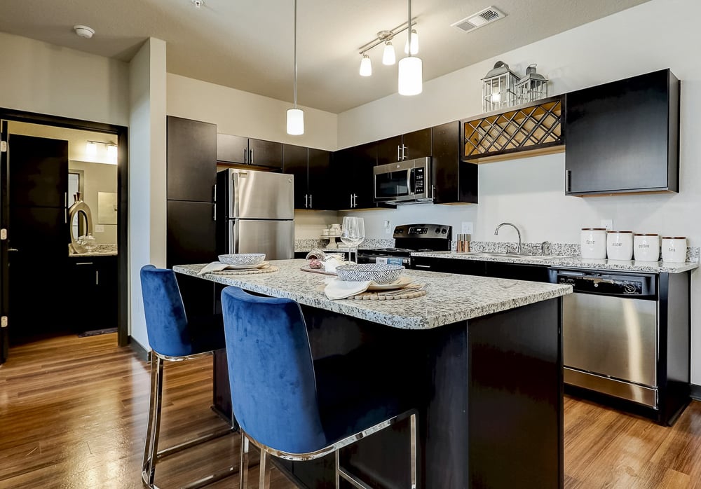 Espresso cabinets, granite counters, stainless steel appliances and huge island at Springs at Newnan Apartments in Georgia