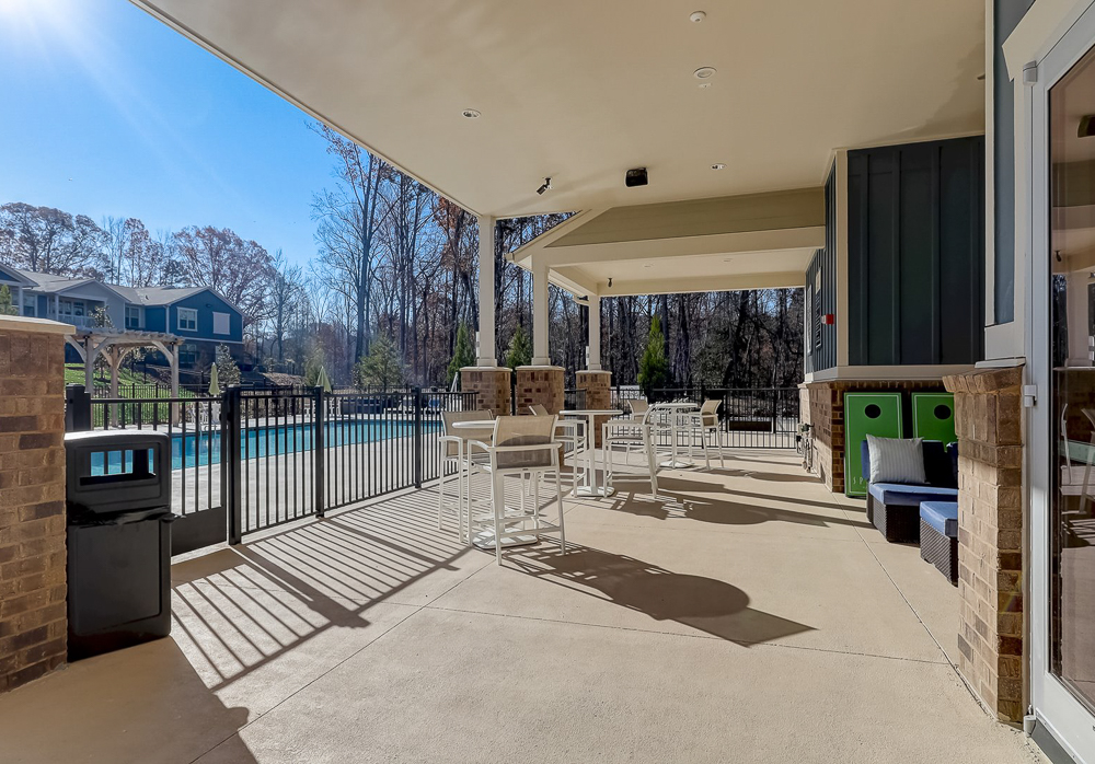 Pool deck with games and seating at Springs at Newnan Apartments in Georgia-69