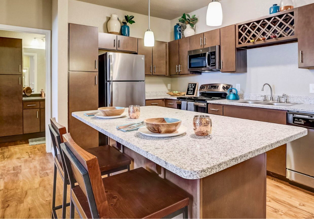 Luxury apartment kitchen with granite countertops and stainless steel appliances at Springs at Round Rock in Round Rock, TX.