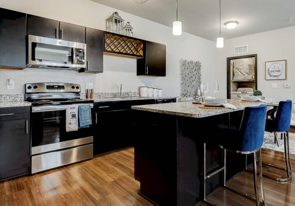 Luxury kitchens featuring granite counter tops and stainless steel appliances at Springs at McDonough apartments.