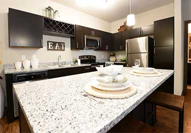 Luxury apartment kitchen with granite countertops and stainless steel appliances